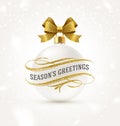 White Christmas bauble with golden bow ribbon and Christmas greeting with glitter gold flourishes elements. Royalty Free Stock Photo